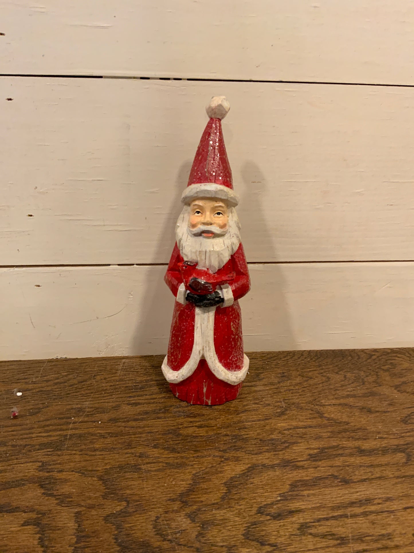 8.5” wood carved Santa w/ cardinal